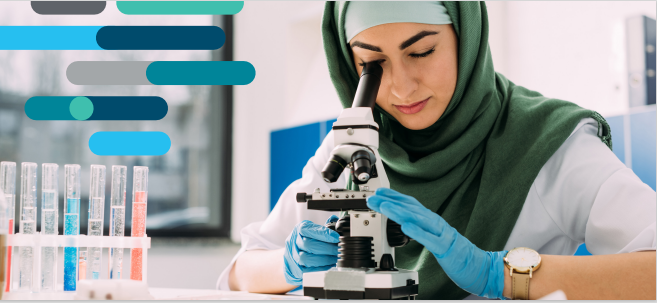 Women in a hijab using a microscope