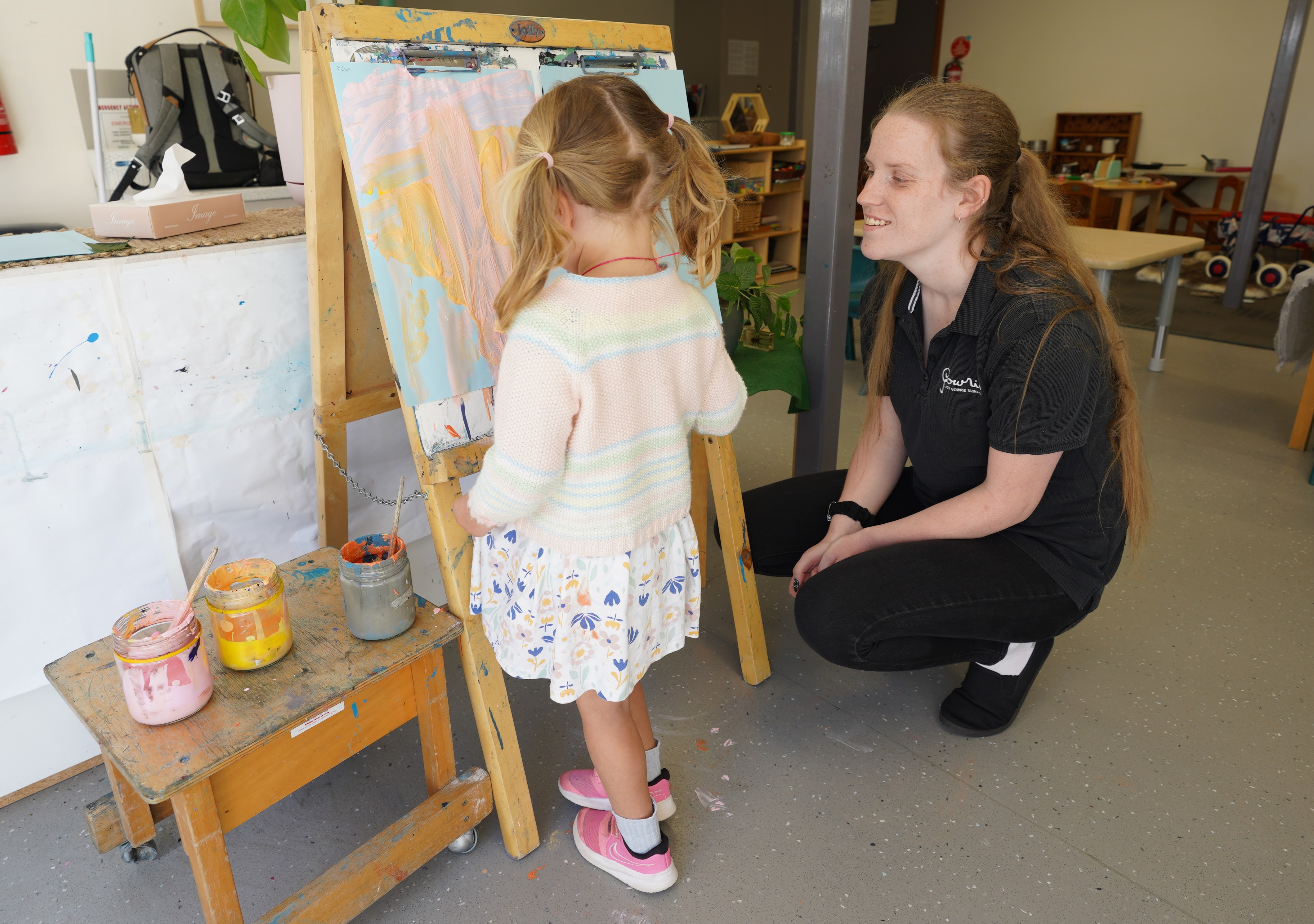 Natasha (right) watching a child paint