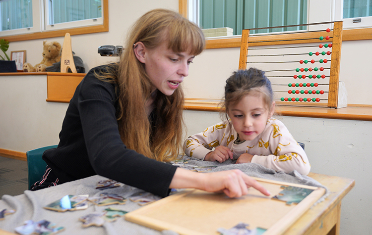 Lauren (left) and a child sitting at a table