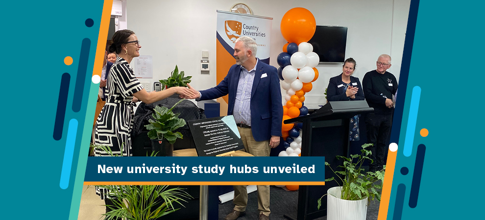 New university study hubs unveiled - Two people shaking hands, smiling and standing in front of a university banner and behind the placard detailing the opening of the Regional University Study Hub being opened.