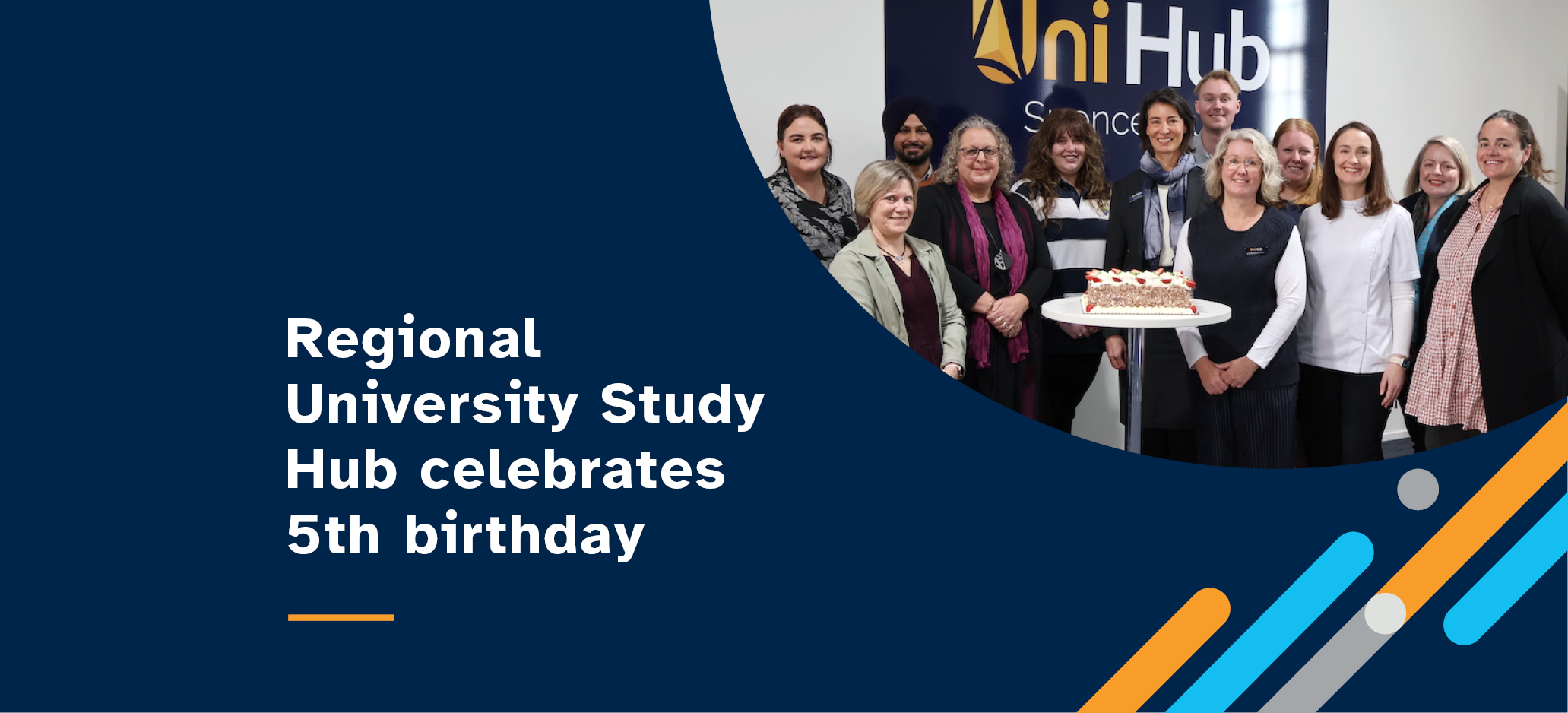 12 people standing around a table and cake with the text Regional University Study Hub Celebrates 5th Birthday