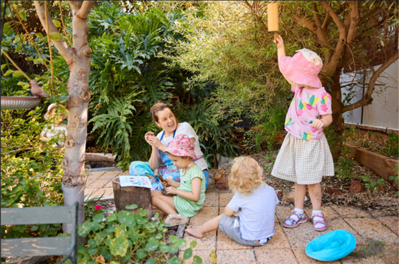 Bambini Di Natura educator Karin in a garden with three children