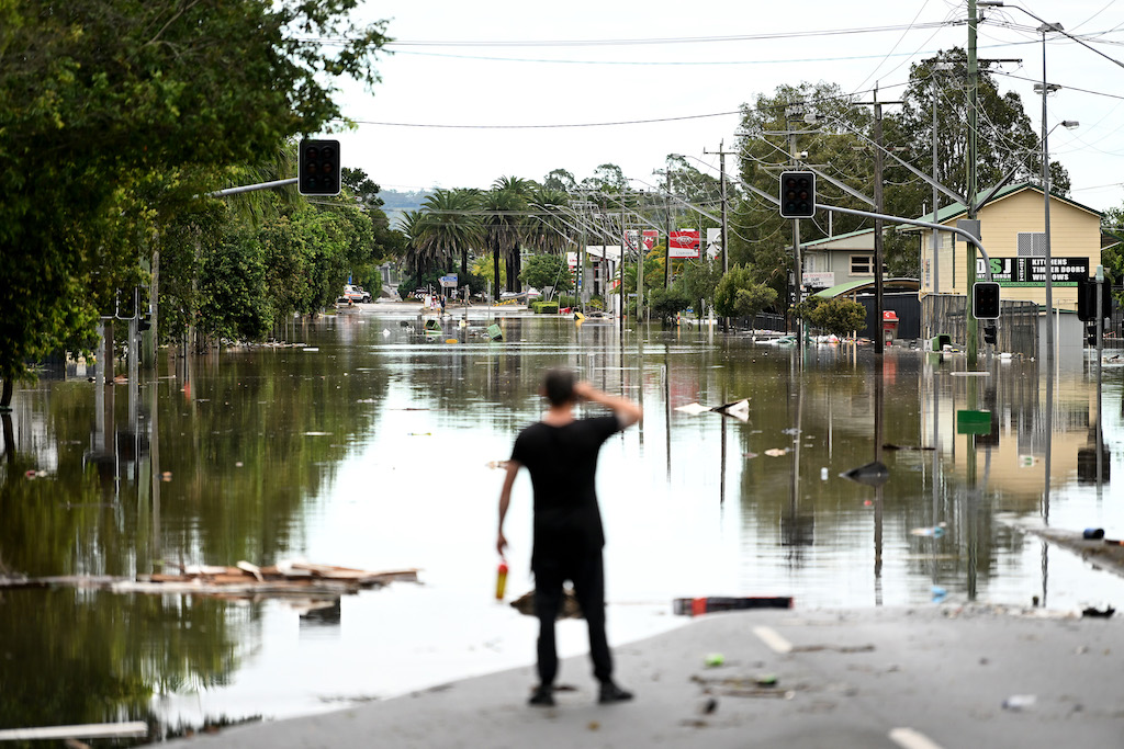 Person looks down flooded main street of town.