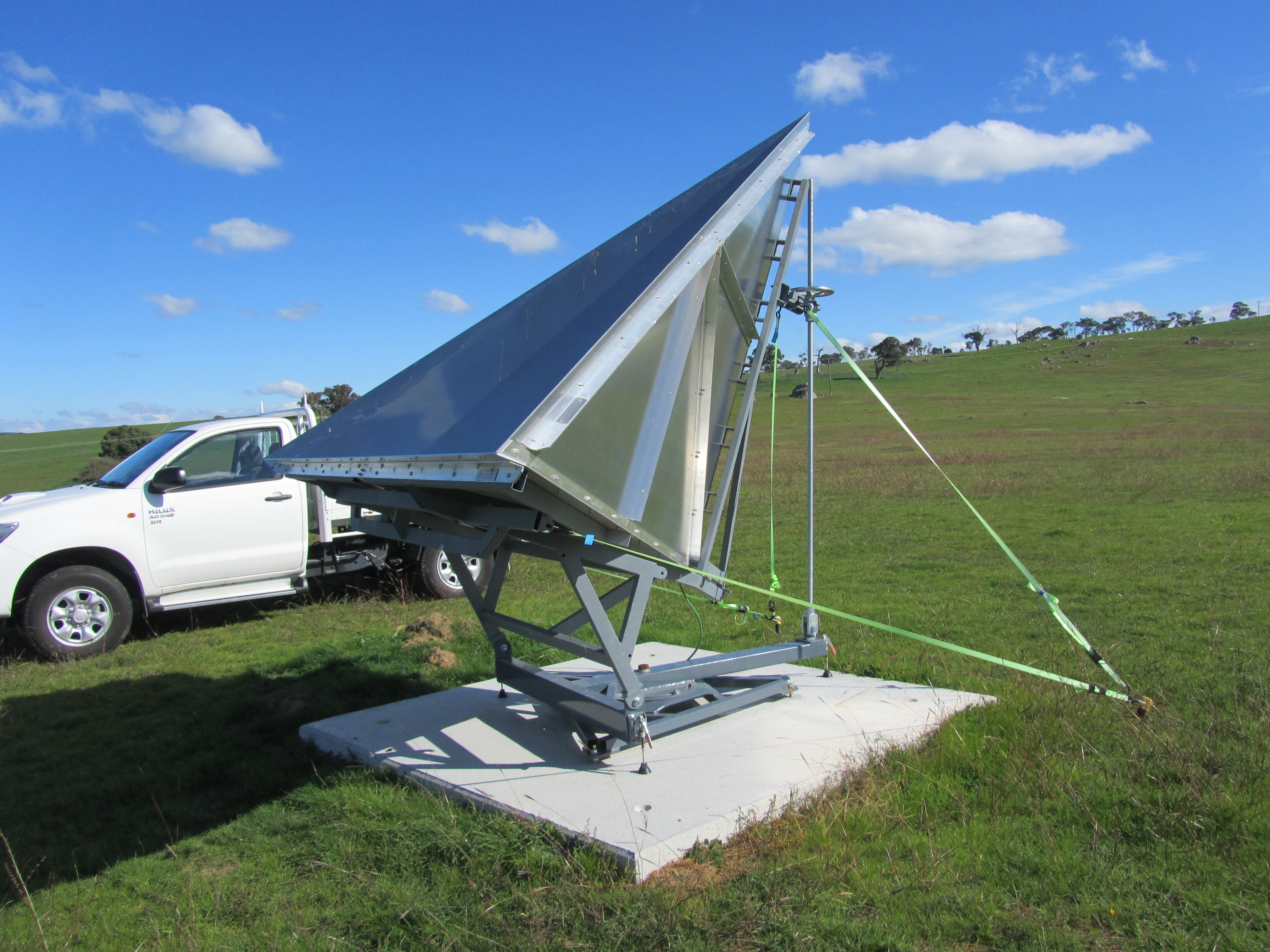 InSAR corner reflector on a concrete slab in a grassy paddock.