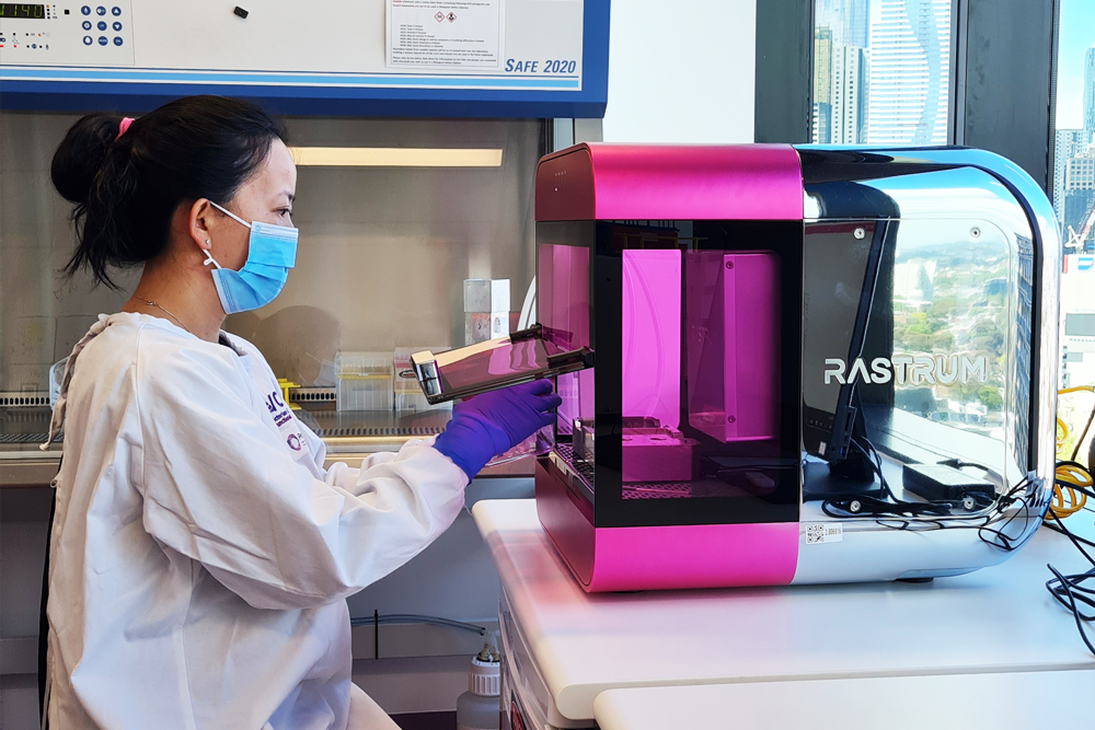 Technician using a RASTRUM 3D bioprinter