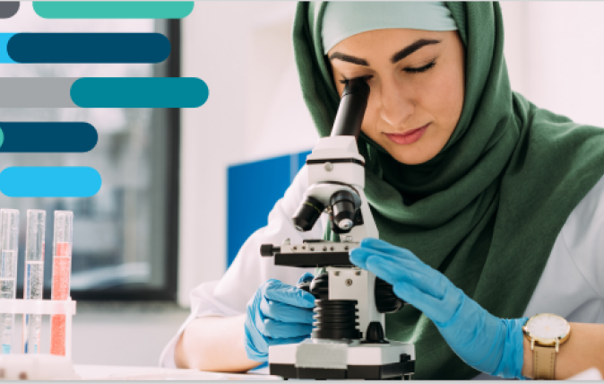 Women in a hijab using a microscope