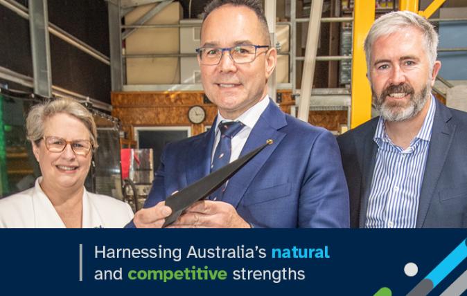 Three people standing in a warehouse or factory and dressed in business attire. Includes the words: Harnessing Australia’s natural and competitive strengths.