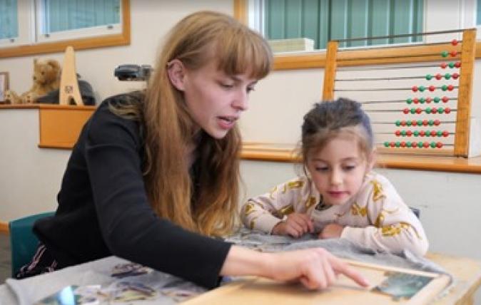 Lauren (left) and a child sitting at a table