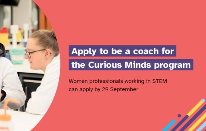 Two women wearing white lab coats working in a laboratory. Includes the words: ‘Apply to be a coach for the Curious Minds program. Women professionals working in STEM can apply by 29 September 2023.’