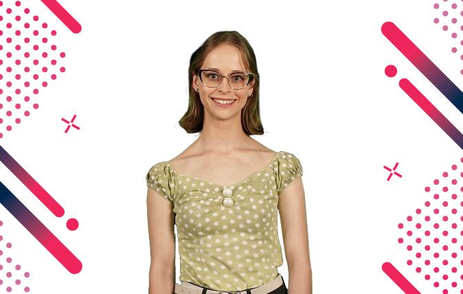 Photo of Georgie smiling, wearing spectacles and a short sleeve, polka dot top with straight shoulder length hair.  She is standing in of a white background with spots, stipes and stars on the left and right boarders.