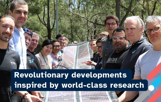 15 people holding a printed solar panel with the words "Revolutionary developments inspired by world-class research"