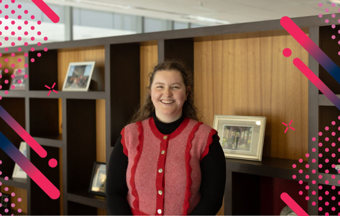 Image of Eloise standing in front of a book shelf
