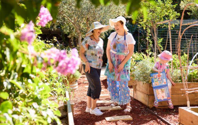 Two people standing outside in a garden